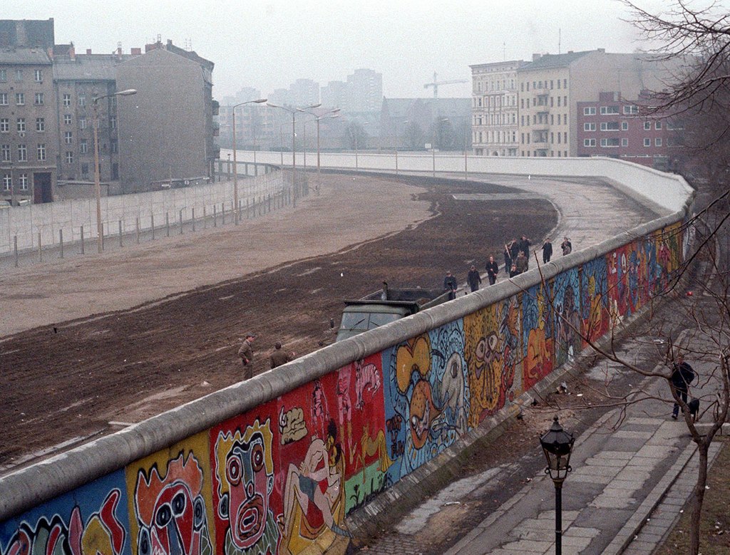 Foto do muro de Berlim em 1986, mostrando diversos grafittis e pichações coloridas separando a Alemanha Ocidental da Oriental. Foto do muro de Berlim em 1986, mostrando diversos grafittis e pichações coloridas separando a Alemanha Ocidental da Oriental.